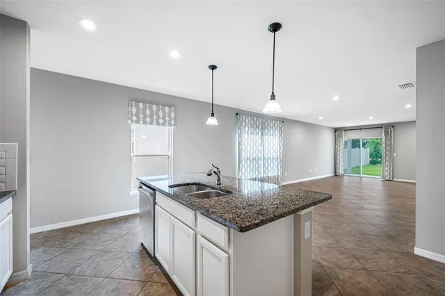 a kitchen with stainless steel appliances granite countertop stove top oven and refrigerator