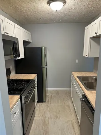 a kitchen with a stove and a refrigerator