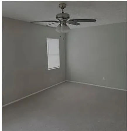 a view of a small space with a fan and a window