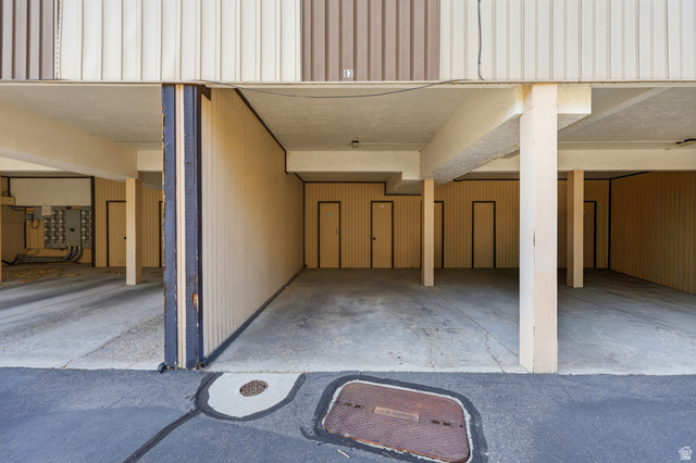1175 Canyon Road, Unit 86 Ogden, UT 84404 - Photo 25 of 29 Covered parking area featuring concrete flooring and multiple access doors