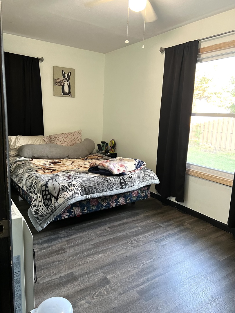 653 South Wayne Place Wheeling, IL 60090 - Photo 11 of 14 a bedroom with a bed and wooden floor