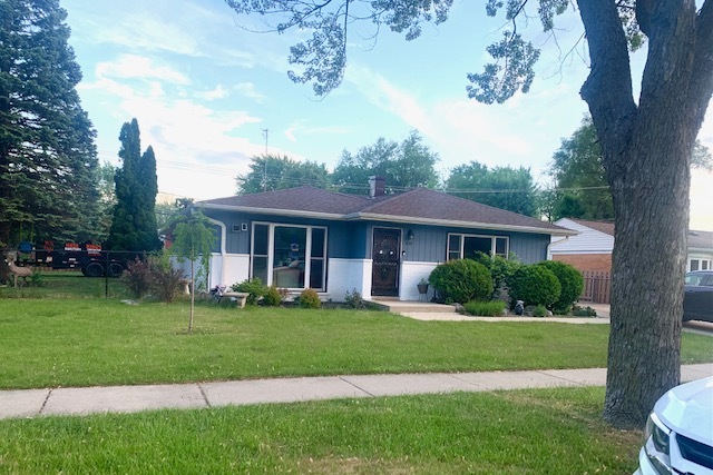653 South Wayne Place Wheeling, IL 60090 - Photo 2 of 14 a front view of a house with a yard