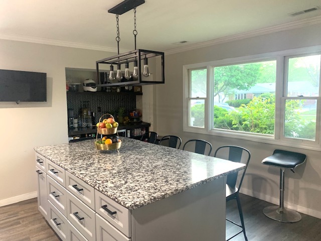 653 South Wayne Place Wheeling, IL 60090 - Photo 5 of 14 a kitchen with a table chairs and a wooden floor