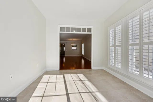 a view of a hallway with an empty room and a window