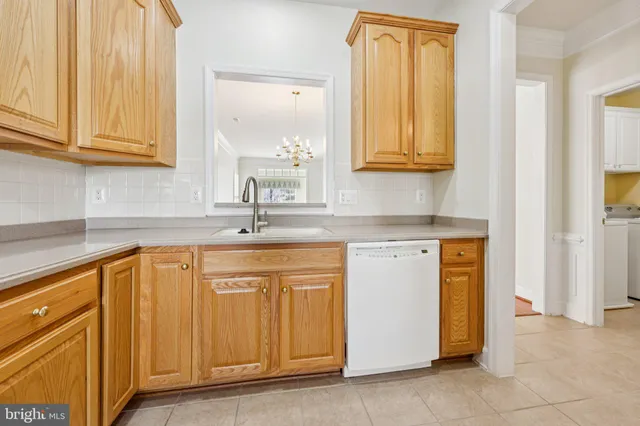 a kitchen with stainless steel appliances granite countertop a sink and dishwasher with cabinets
