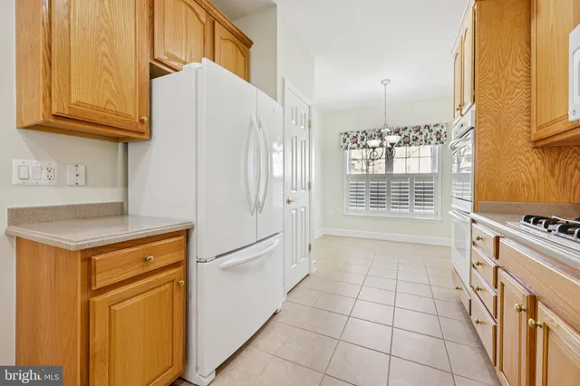 a kitchen with stainless steel appliances granite countertop a stove a refrigerator and a cabinets