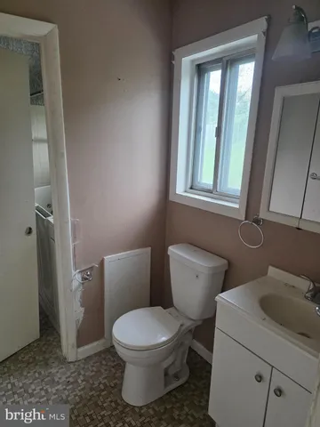 a white toilet sitting next to a bathroom sink