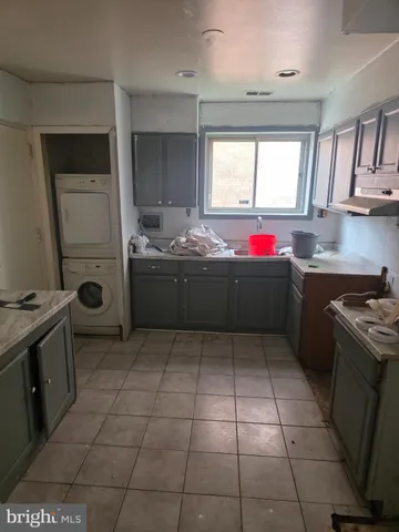 a kitchen with a sink a stove and a microwave