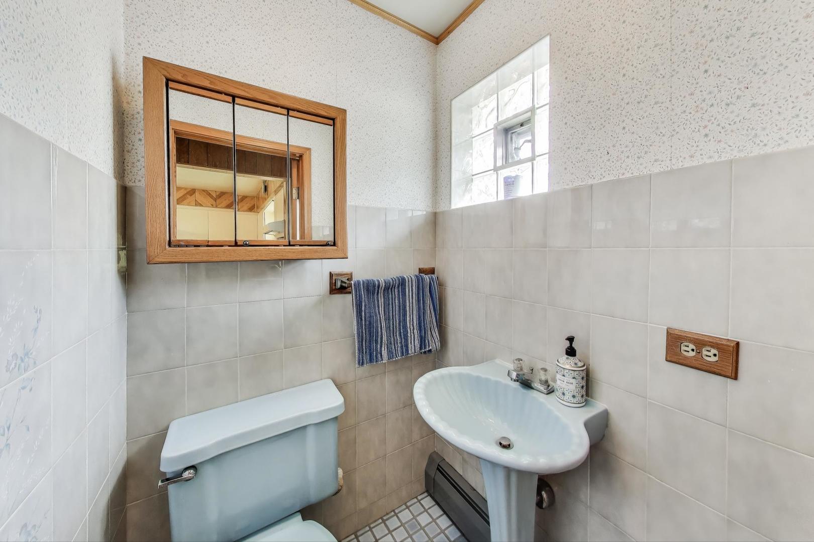 4121 Maple Avenue Lyons, IL 60534 - Photo 11 of 32 a bathroom with a sink and a mirror
