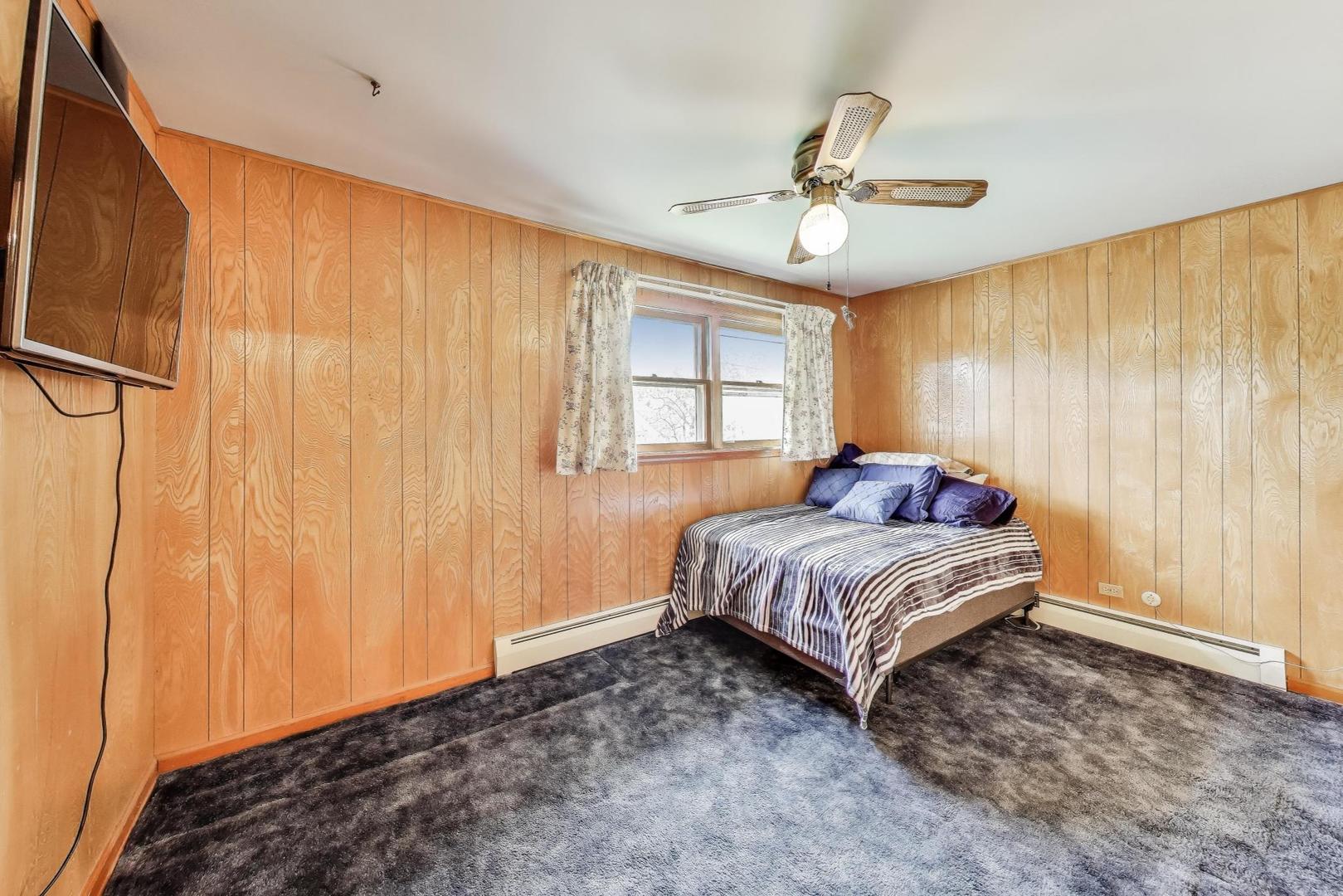 4121 Maple Avenue Lyons, IL 60534 - Photo 17 of 32 a bed sitting in a spacious bedroom next to a window