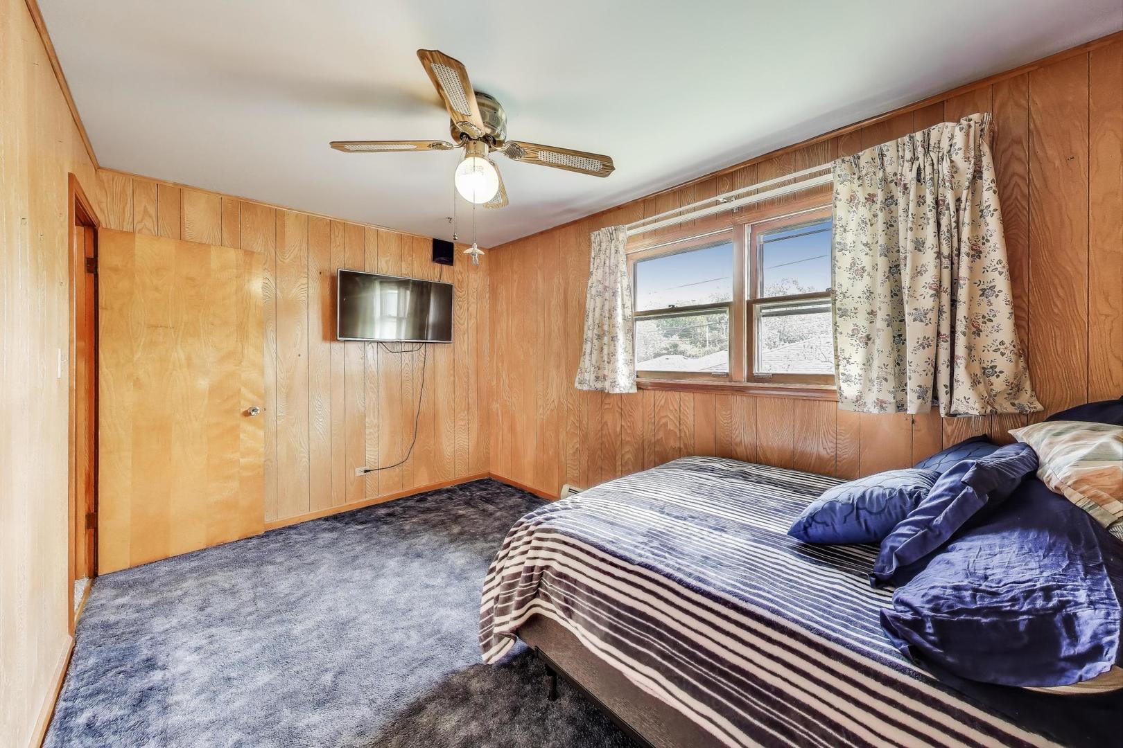 4121 Maple Avenue Lyons, IL 60534 - Photo 18 of 32 a bedroom with a large bed and a window