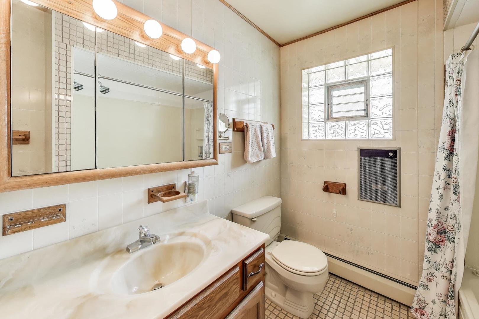 4121 Maple Avenue Lyons, IL 60534 - Photo 19 of 32 a bathroom with a sink toilet and mirror