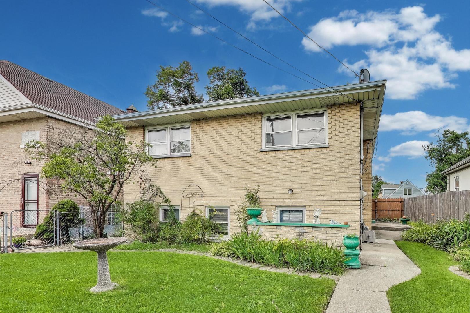4121 Maple Avenue Lyons, IL 60534 - Photo 25 of 32 a front view of a house with a garden and plants