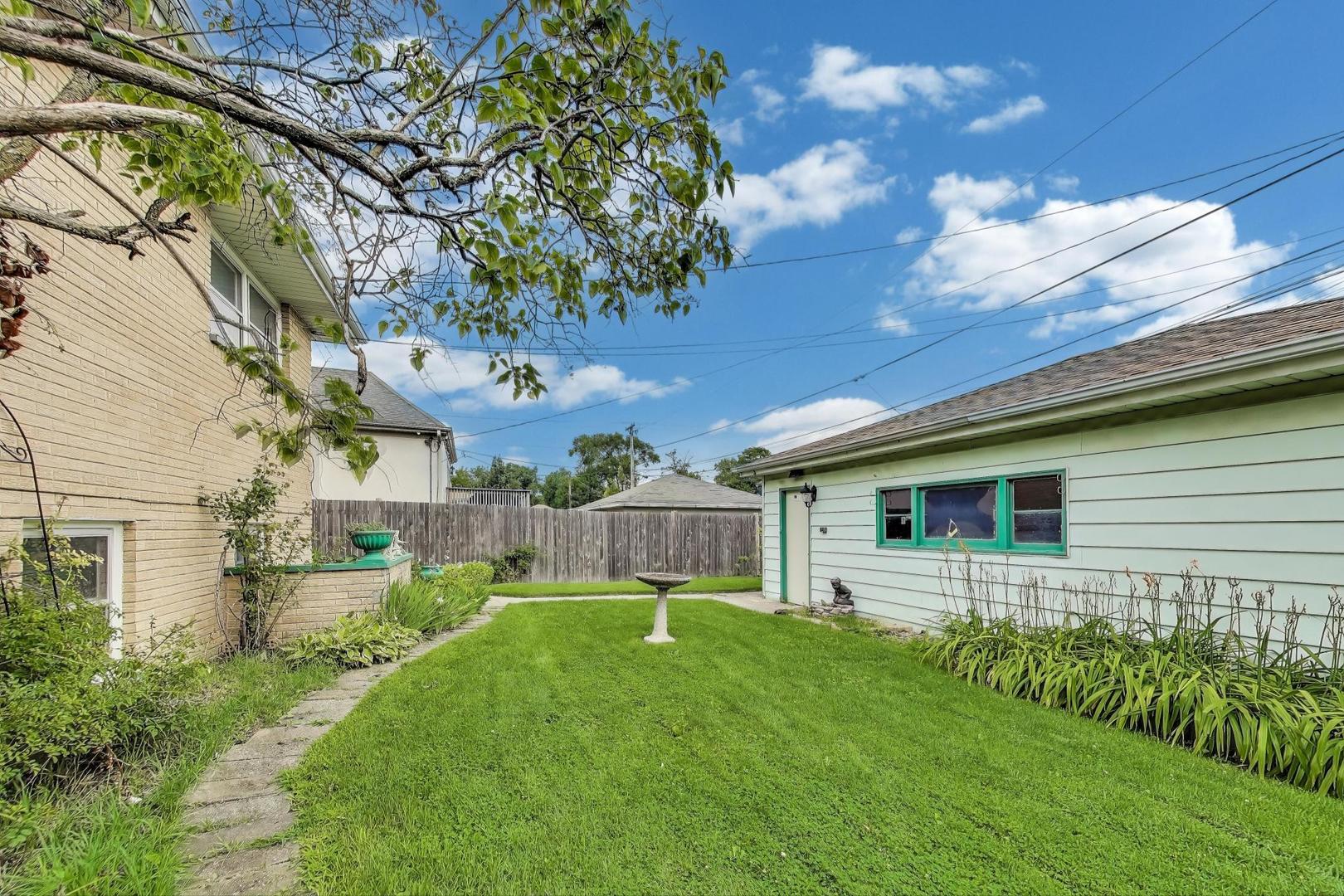 4121 Maple Avenue Lyons, IL 60534 - Photo 28 of 32 a view of a backyard with plants and large tree