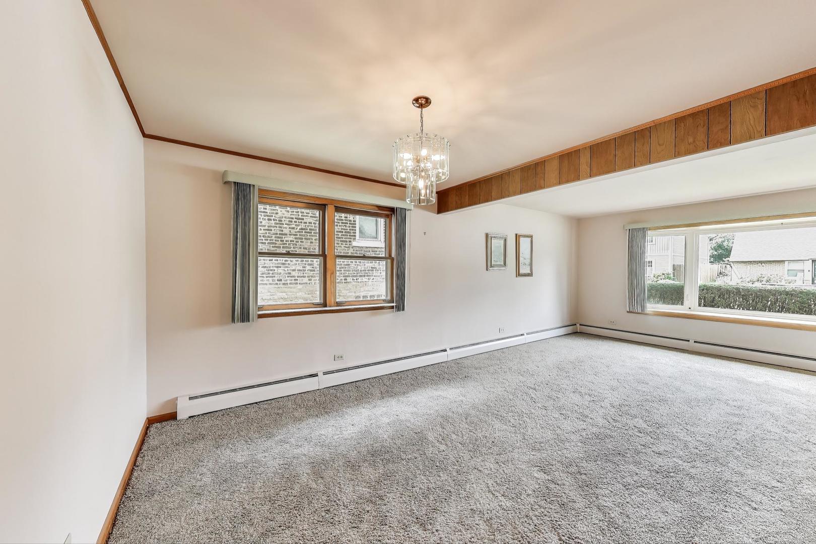 4121 Maple Avenue Lyons, IL 60534 - Photo 7 of 32 an empty room with windows and chandelier