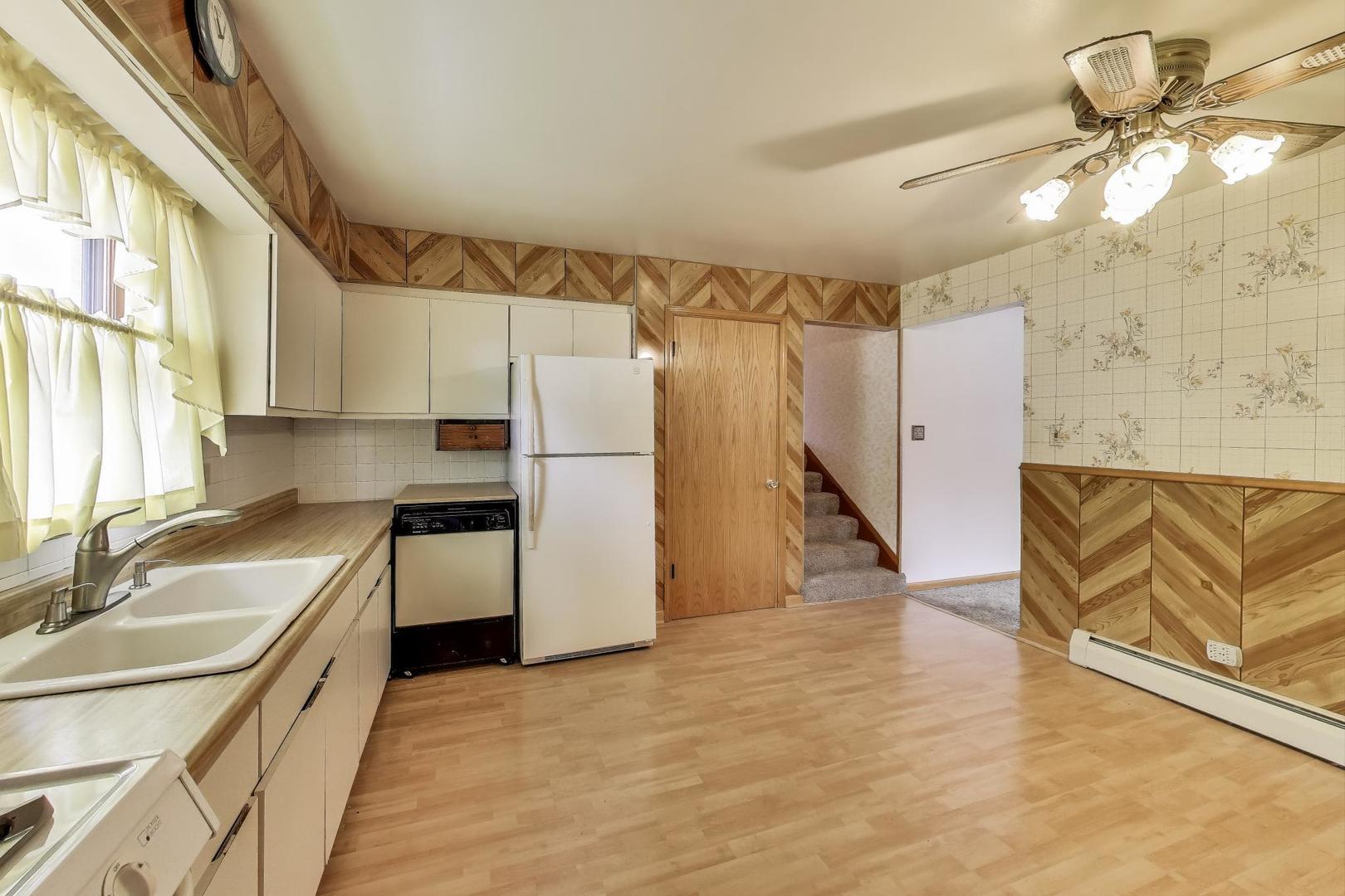 4121 Maple Avenue Lyons, IL 60534 - Photo 9 of 32 a kitchen with granite countertop a refrigerator and a sink