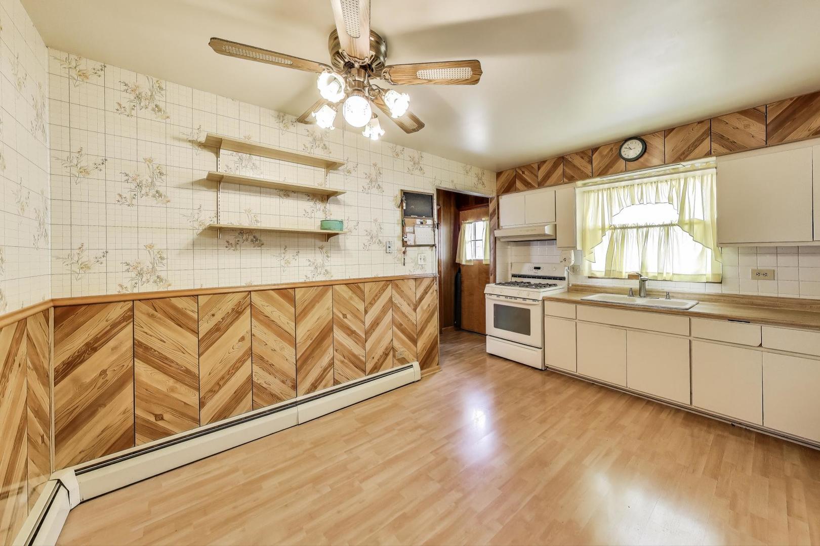 4121 Maple Avenue Lyons, IL 60534 - Photo 10 of 32 a kitchen with stainless steel appliances granite countertop a sink cabinets and wooden floor