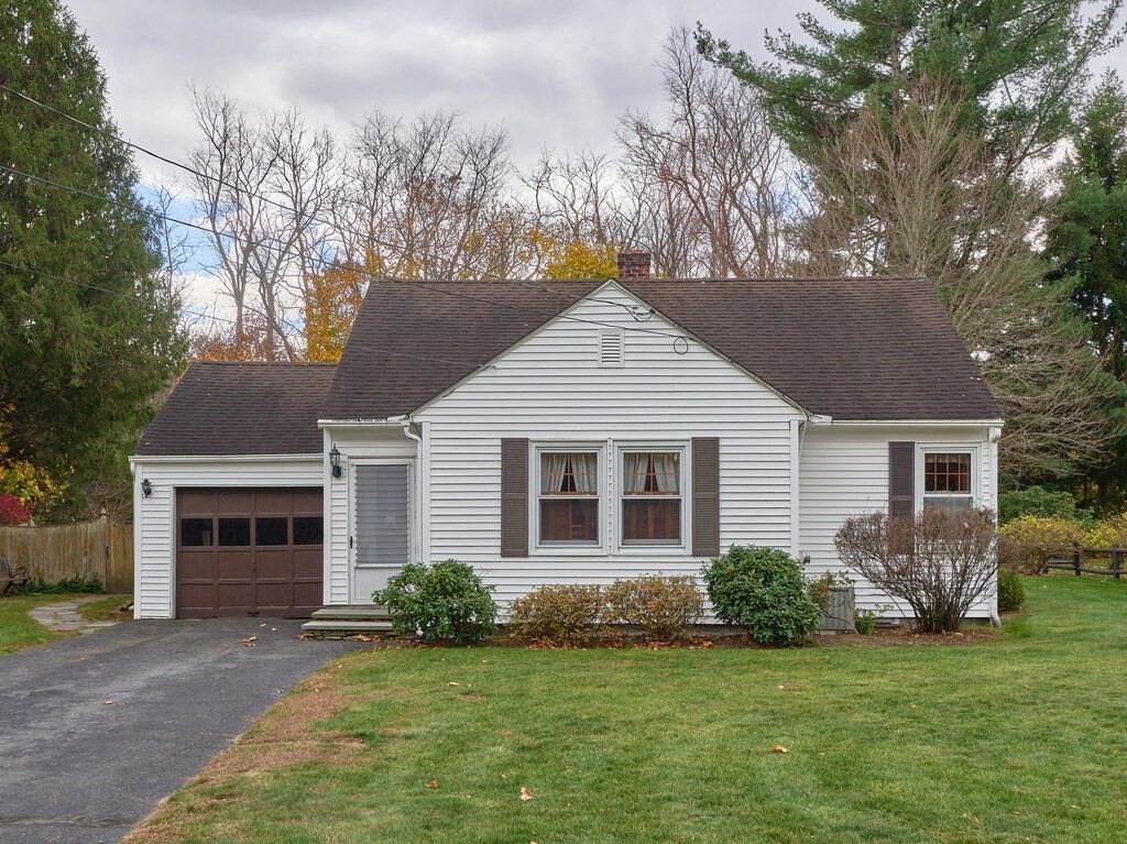 71 Old Common Road Lancaster, MA 01523 - Photo 1 of 39 a view of a yard in front of a house with plants and large tree