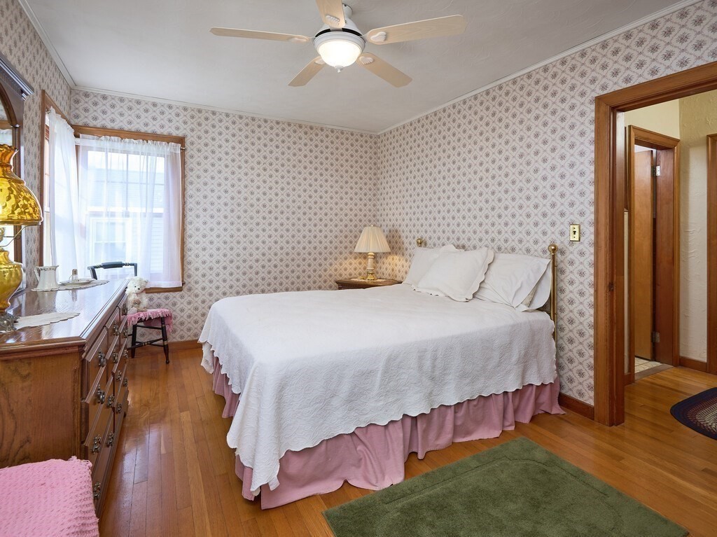 71 Old Common Road Lancaster, MA 01523 - Photo 16 of 39 a bedroom with a bed and wooden floor