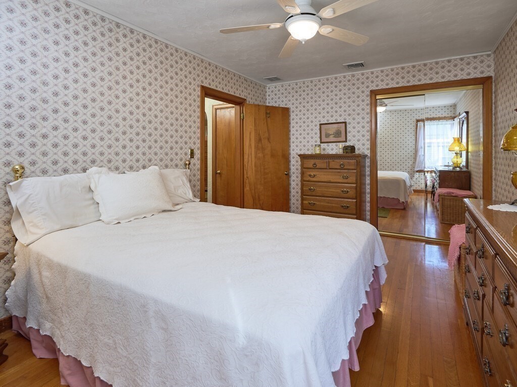 71 Old Common Road Lancaster, MA 01523 - Photo 17 of 39 a bedroom with a bed and a chandelier