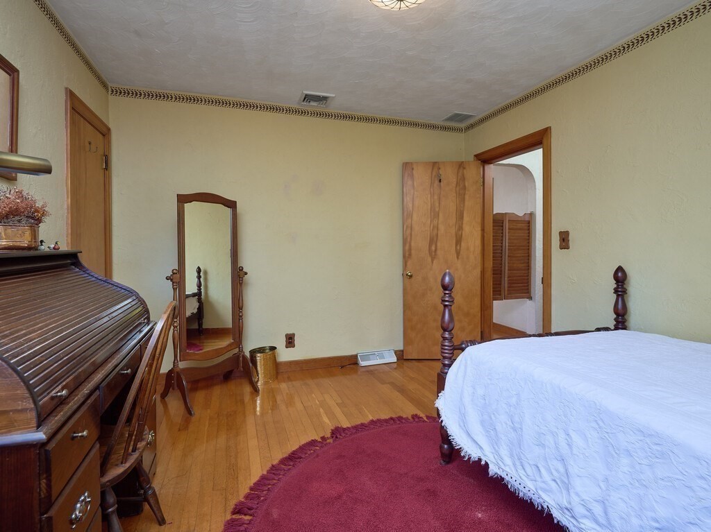 71 Old Common Road Lancaster, MA 01523 - Photo 18 of 39 a bedroom with a bed and wooden floor
