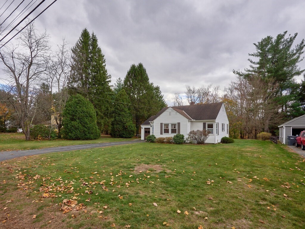 71 Old Common Road Lancaster, MA 01523 - Photo 32 of 39 a view of a big house with a big yard and large trees