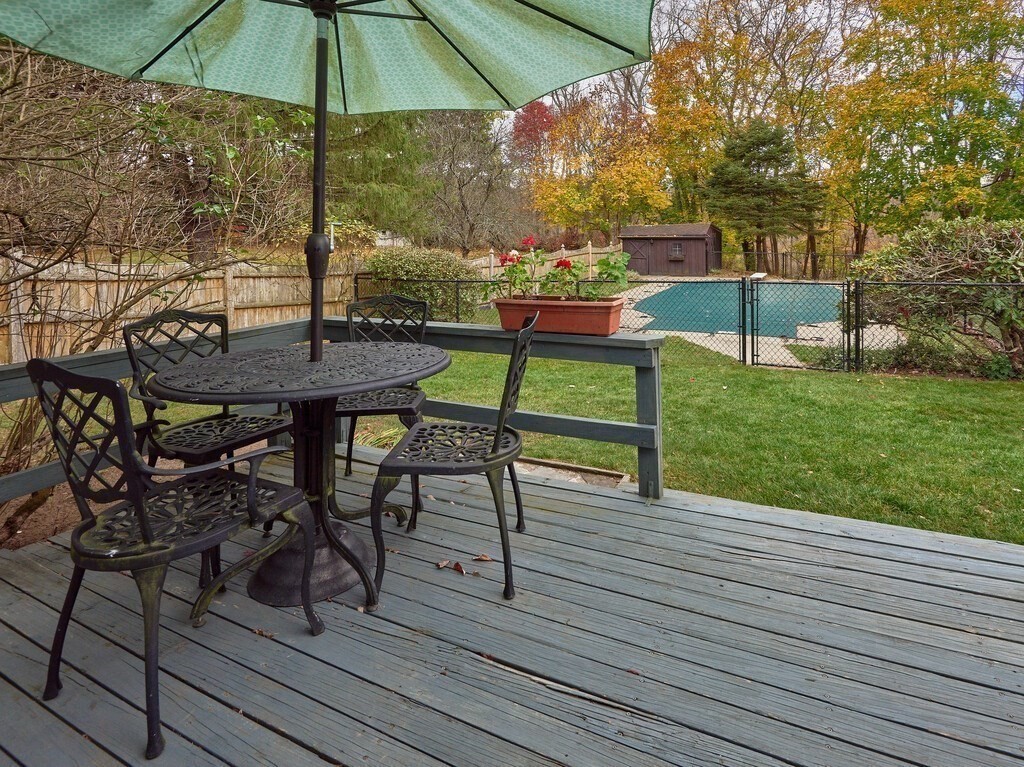 71 Old Common Road Lancaster, MA 01523 - Photo 36 of 39 a view of a table and chairs under an umbrella