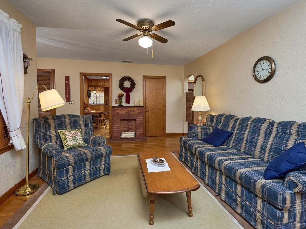 71 Old Common Road Lancaster, MA 01523 - Photo 5 of 39 a living room with furniture a couch and a ceiling fan