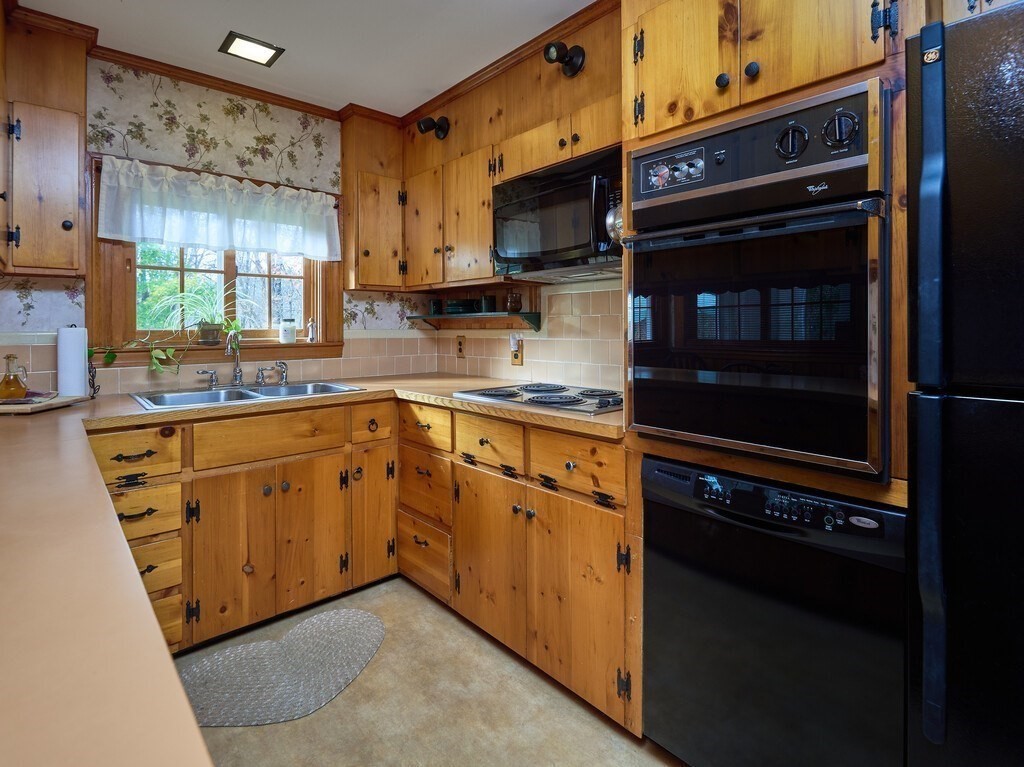 71 Old Common Road Lancaster, MA 01523 - Photo 6 of 39 a kitchen with stainless steel appliances and cabinets
