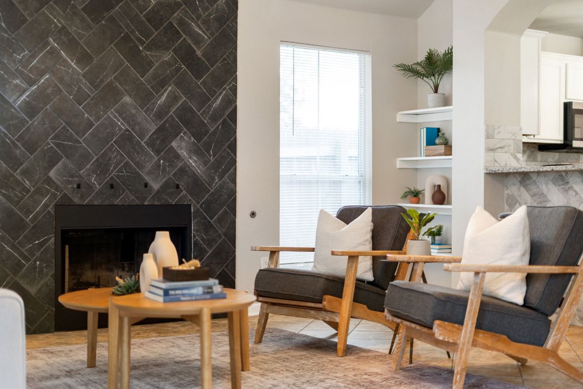 a living room with furniture and a fireplace
