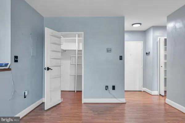 a view of empty room with wooden floor
