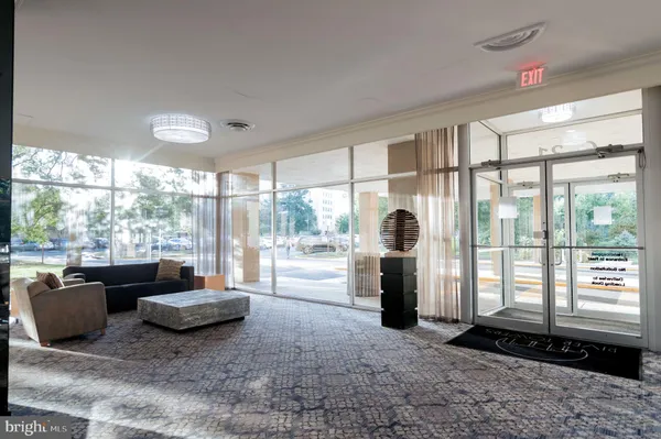 a living room with furniture and large windows
