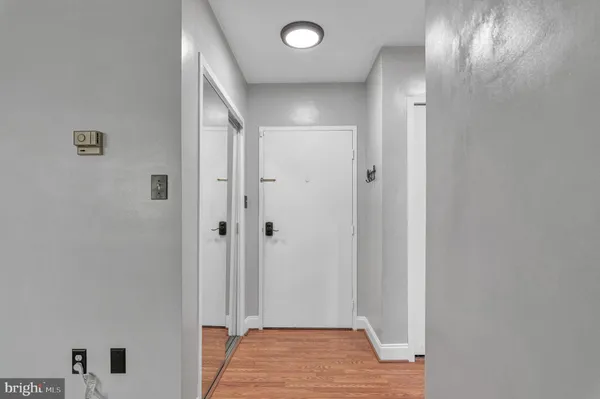 a view of a hallway with wooden floor