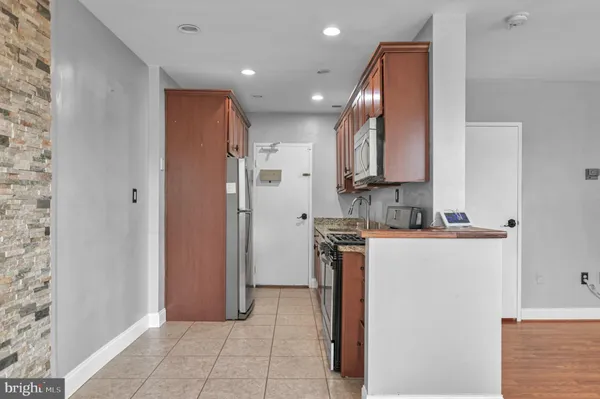 a view of a kitchen with electric appliances
