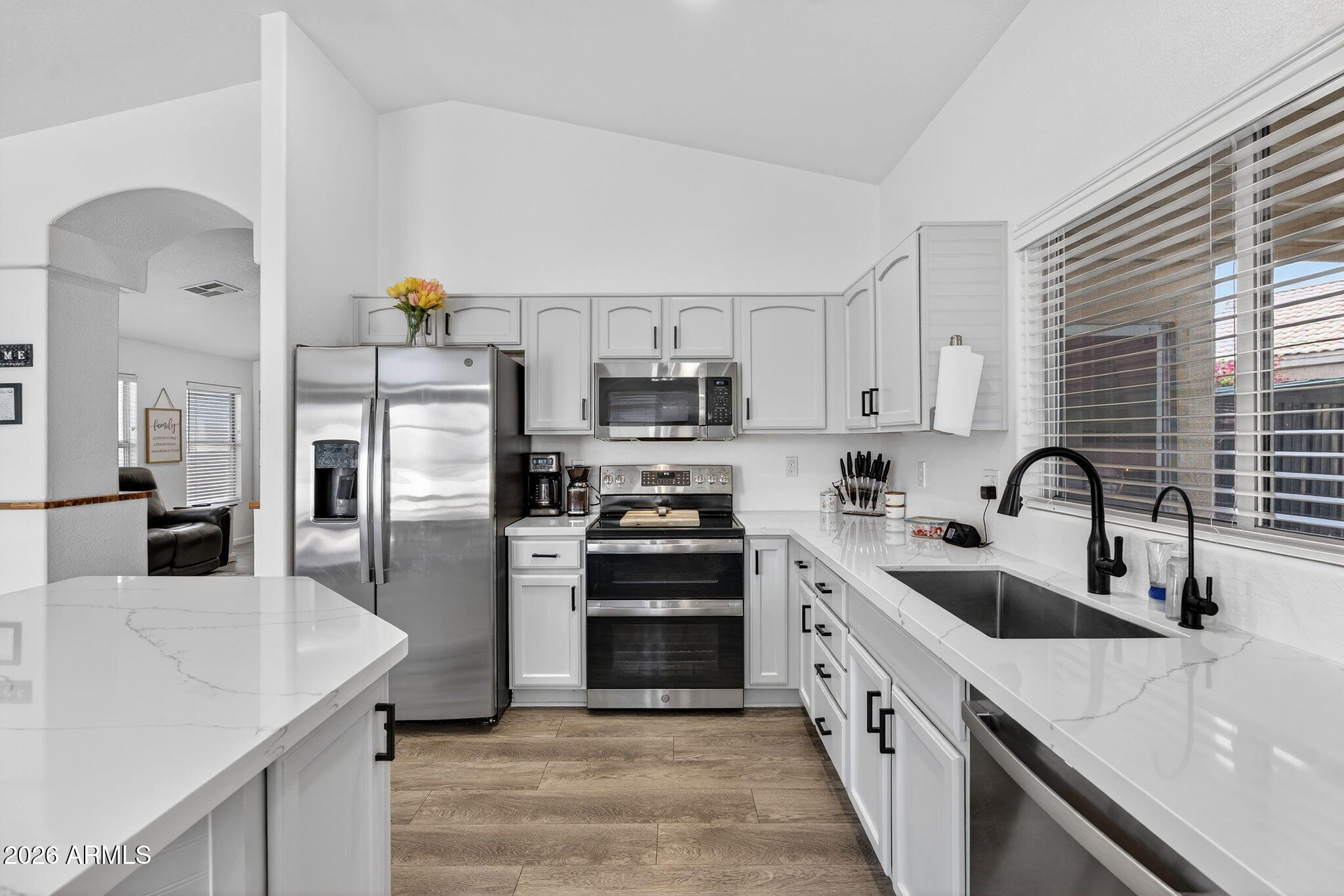 4630 East Dry Creek Road Phoenix, AZ 85044 - Photo 11 of 60 a kitchen with stainless steel appliances granite countertop a sink stove oven and refrigerator