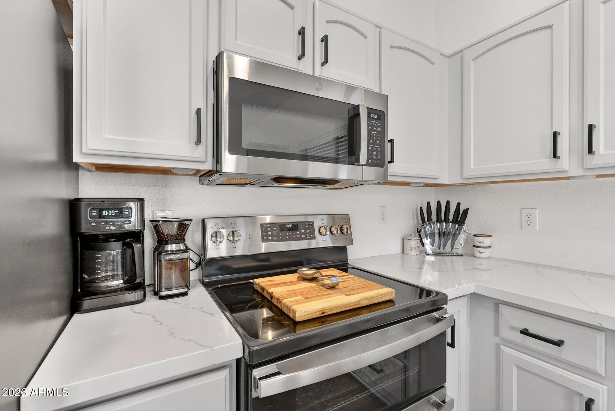 4630 East Dry Creek Road Phoenix, AZ 85044 - Photo 12 of 60 a kitchen with a stove and a microwave