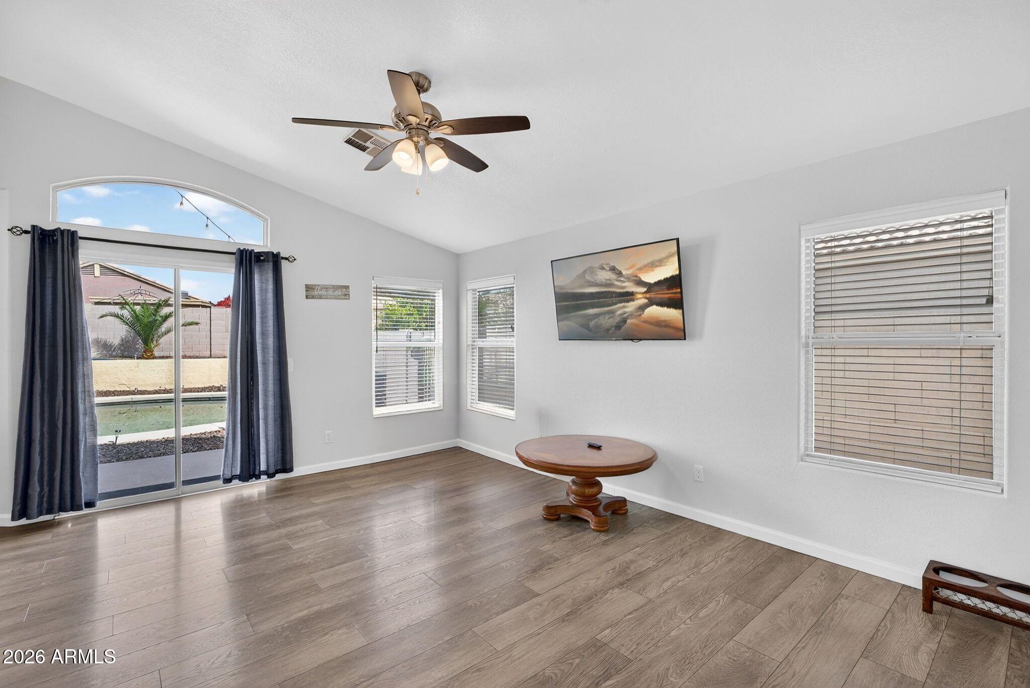 4630 East Dry Creek Road Phoenix, AZ 85044 - Photo 15 of 60 a view of an empty room with a window and wooden floor