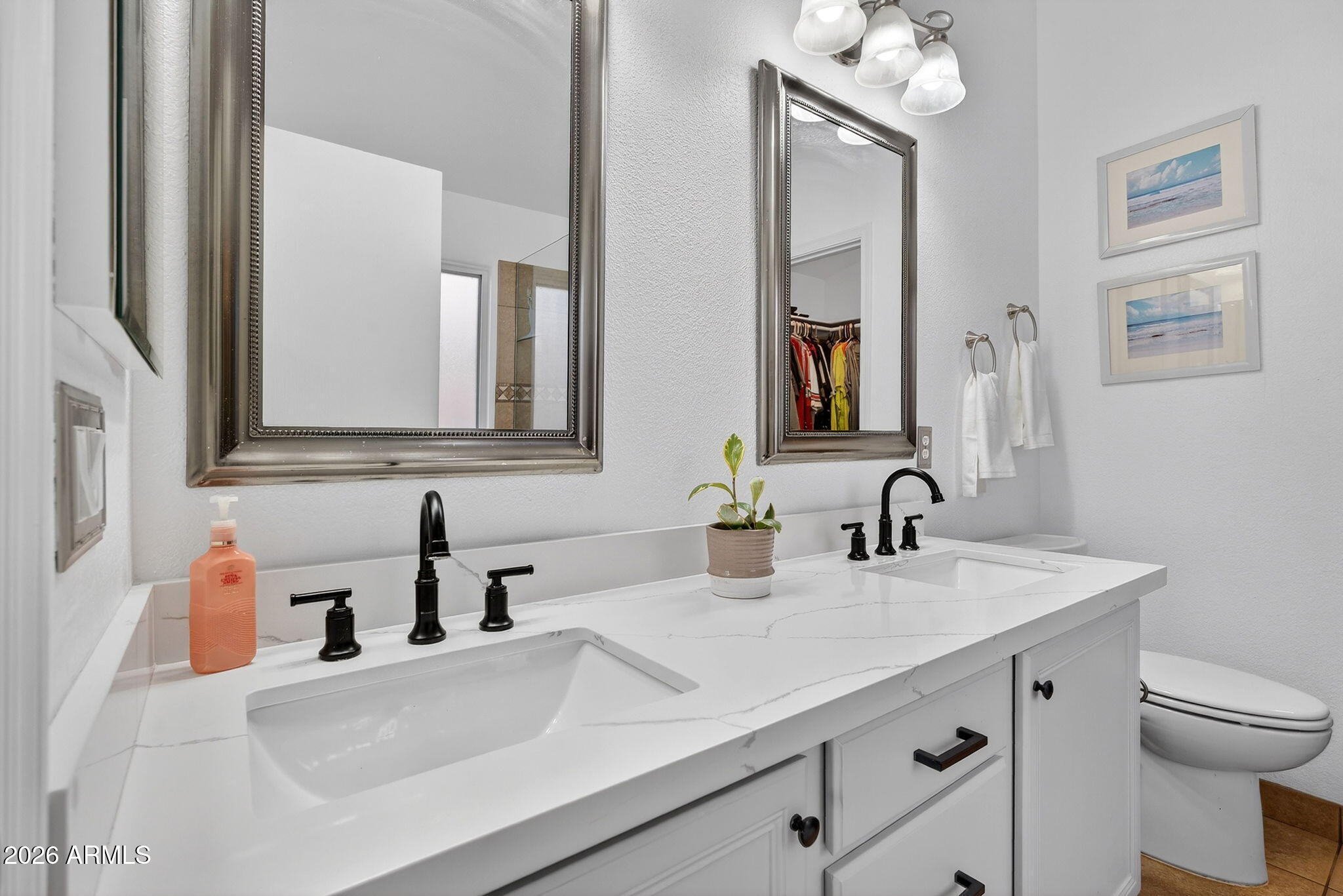 4630 East Dry Creek Road Phoenix, AZ 85044 - Photo 23 of 60 a bathroom with double vanity sink a toilet and mirror