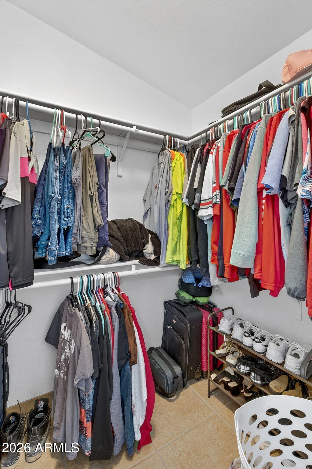 4630 East Dry Creek Road Phoenix, AZ 85044 - Photo 27 of 60 a view of walk in closet with clothes and shoes