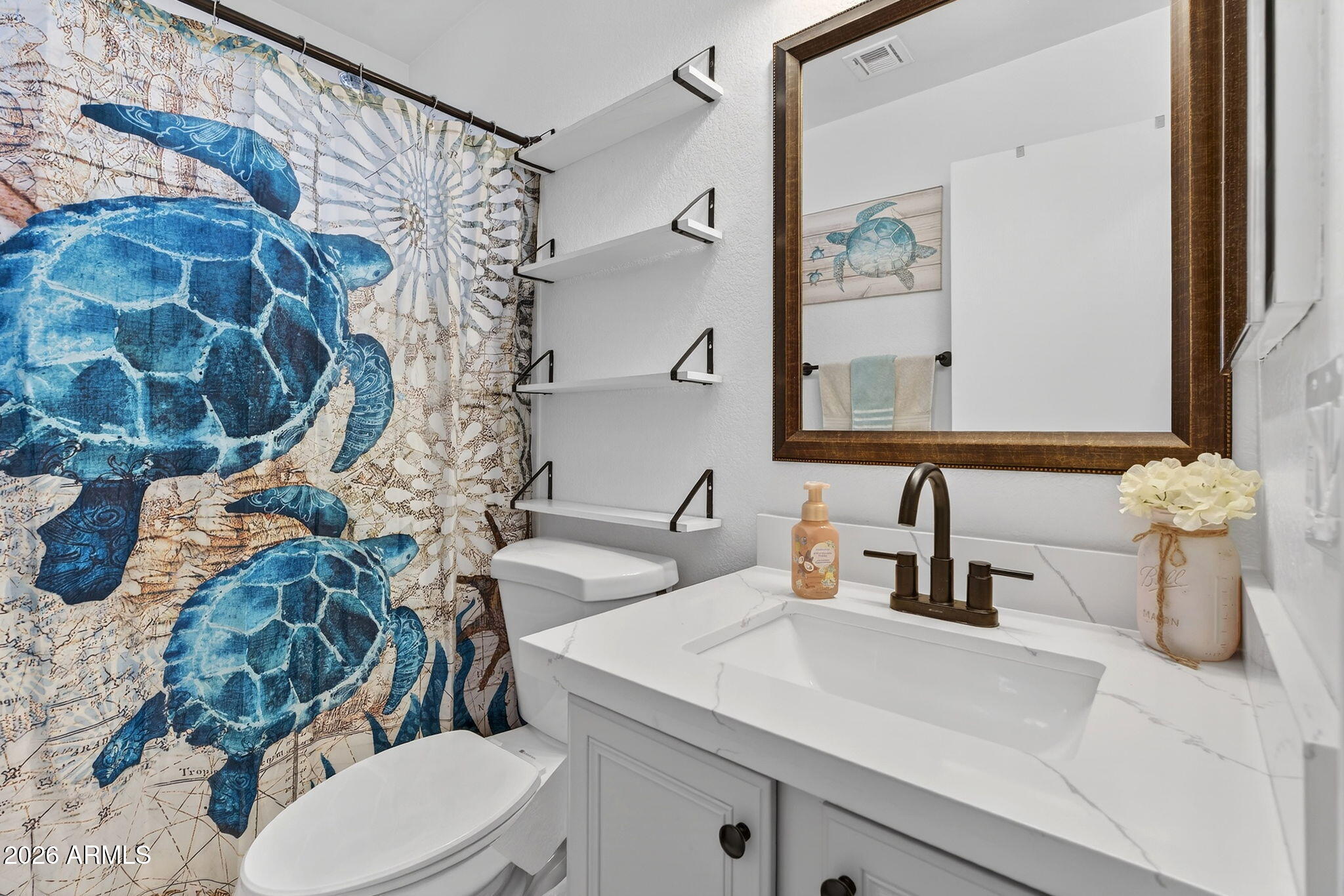 4630 East Dry Creek Road Phoenix, AZ 85044 - Photo 30 of 60 a bathroom with a sink and mirror with toilet