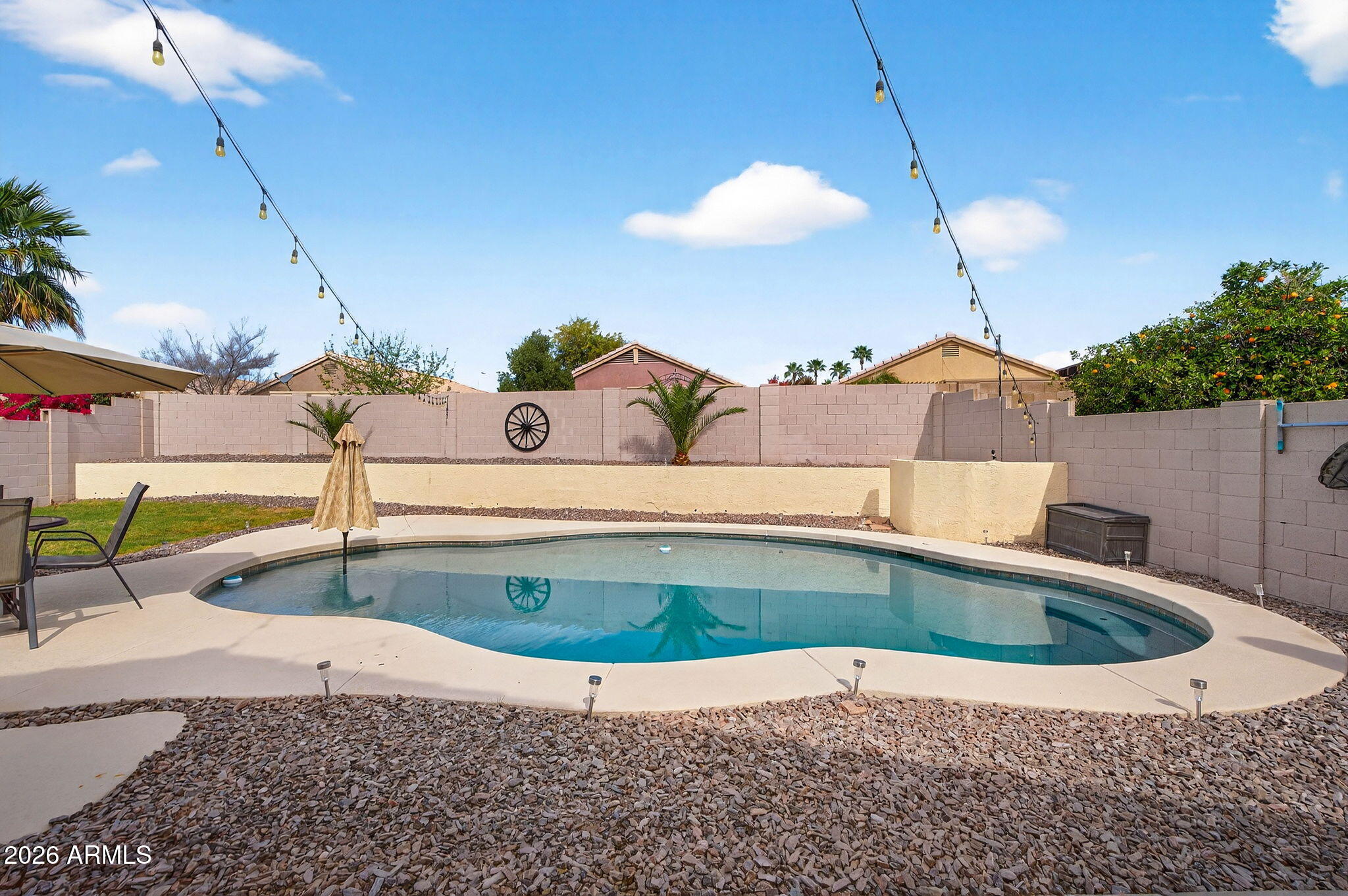 4630 East Dry Creek Road Phoenix, AZ 85044 - Photo 36 of 60 a view of a swimming pool with a table and chairs