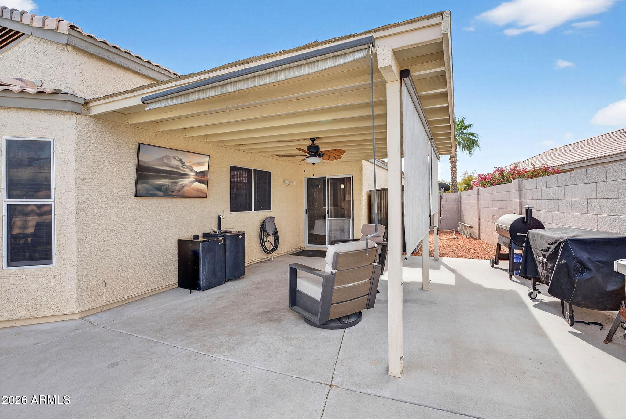 4630 East Dry Creek Road Phoenix, AZ 85044 - Photo 39 of 60 a view of a patio with dining table and chairs with wooden fence