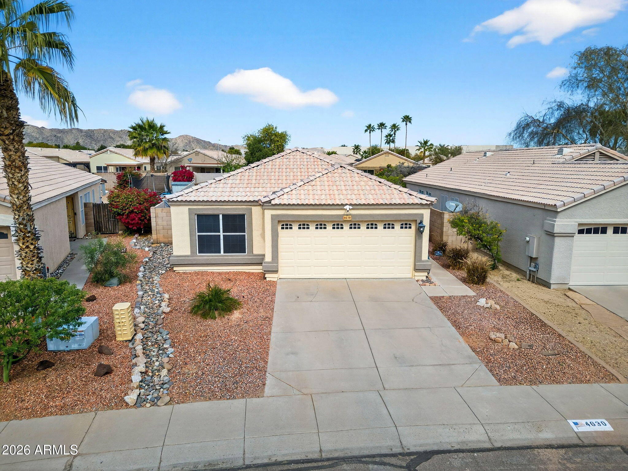 4630 East Dry Creek Road Phoenix, AZ 85044 - Photo 42 of 60 a view of a house with a yard and potted plants