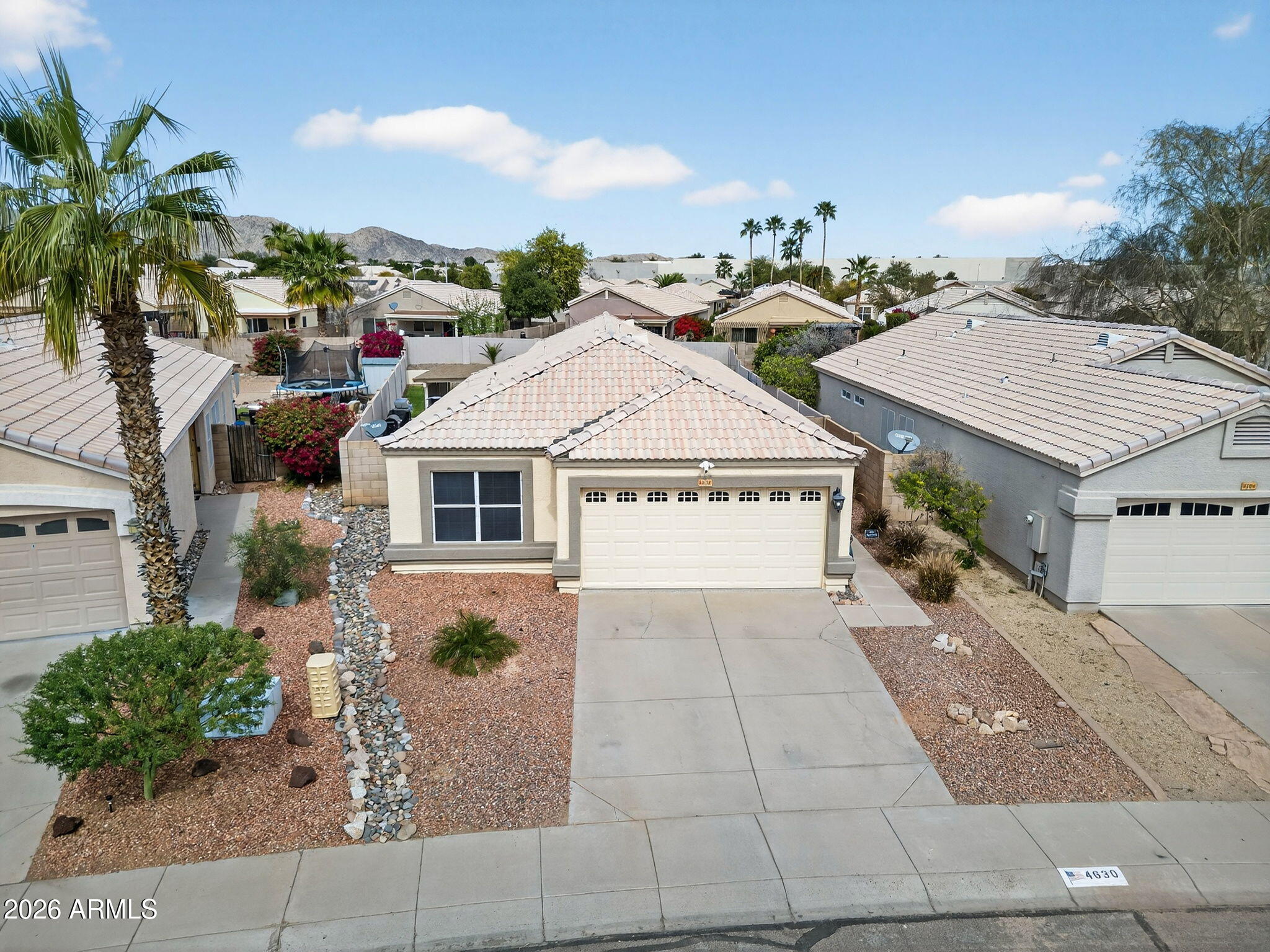 4630 East Dry Creek Road Phoenix, AZ 85044 - Photo 44 of 60 a view of a house with a yard and potted plants