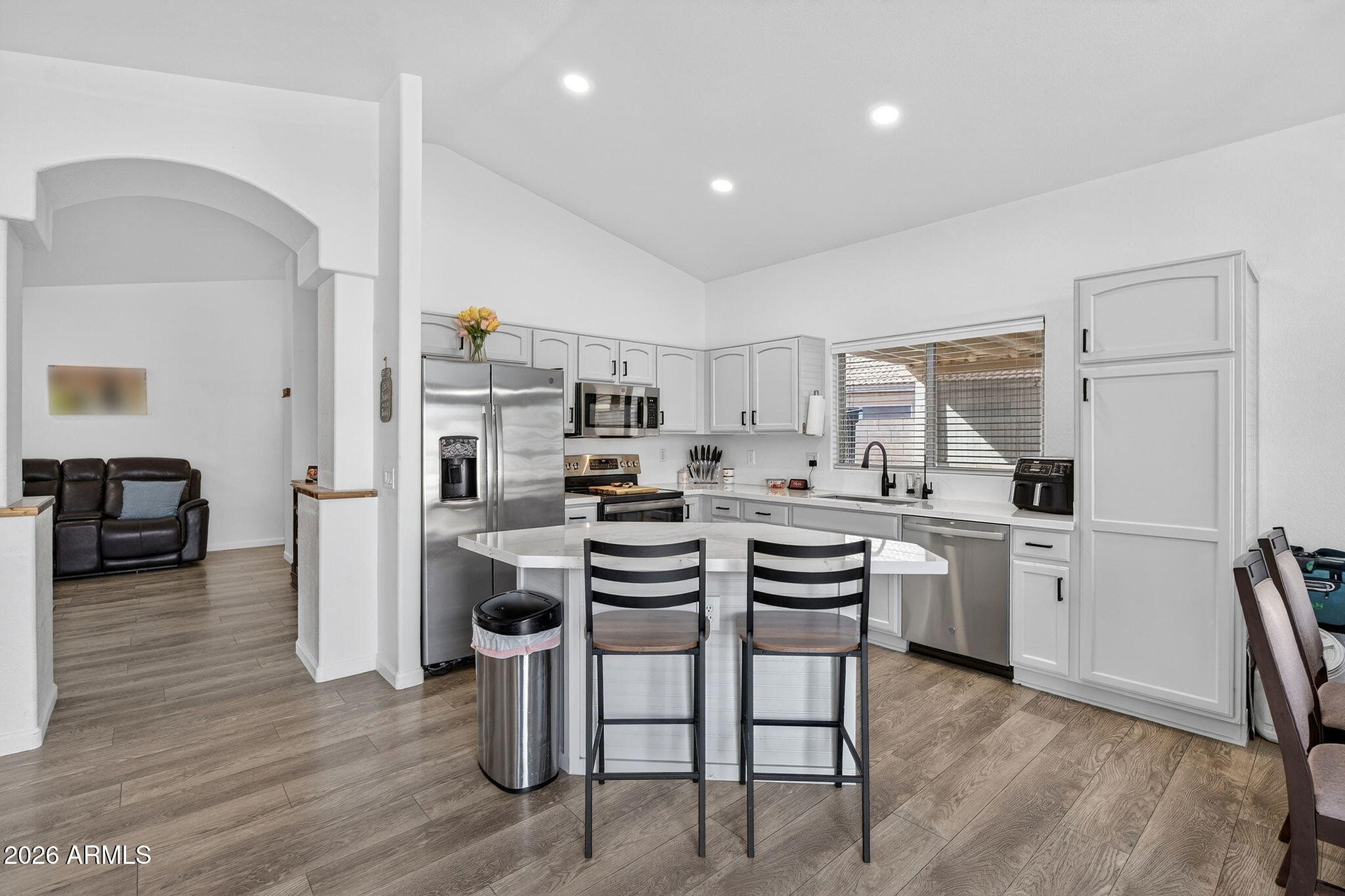 4630 East Dry Creek Road Phoenix, AZ 85044 - Photo 9 of 60 a kitchen with white cabinets and stainless steel appliances