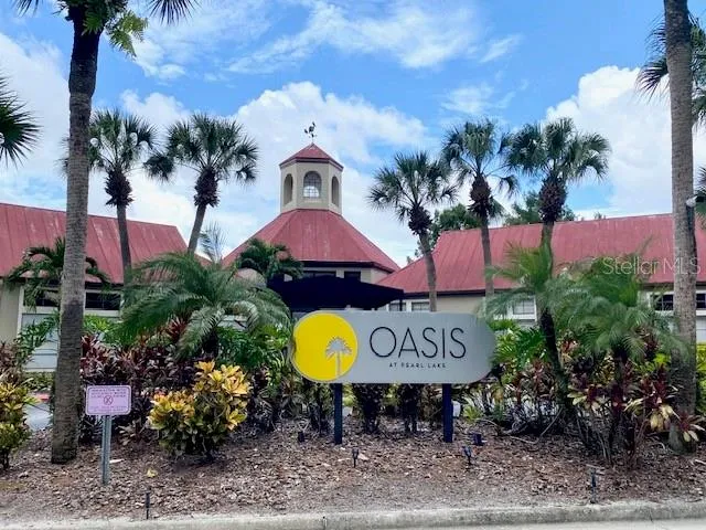 a view of a cafe with a table and chairs under an umbrella