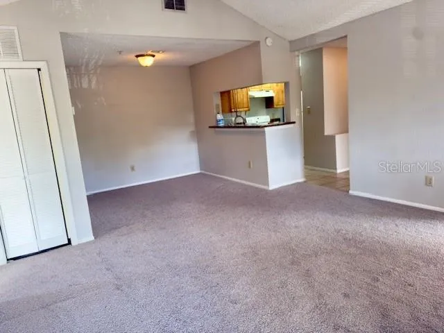 a view of a kitchen with wooden floor and a sink