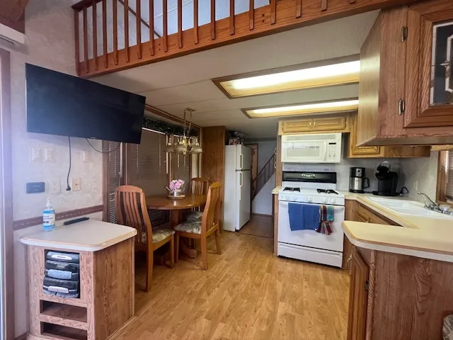 a kitchen with a sink appliances and cabinets
