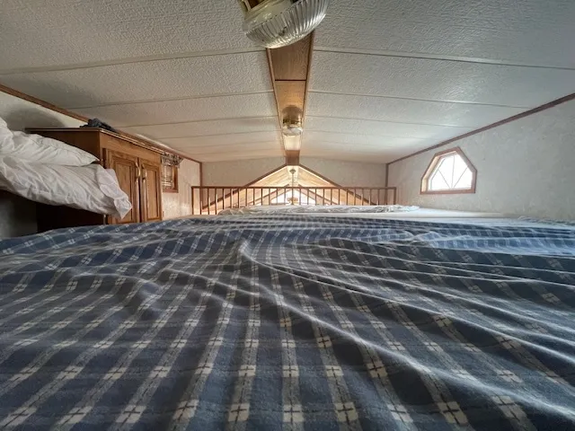 a bed sitting in a bedroom next to a window