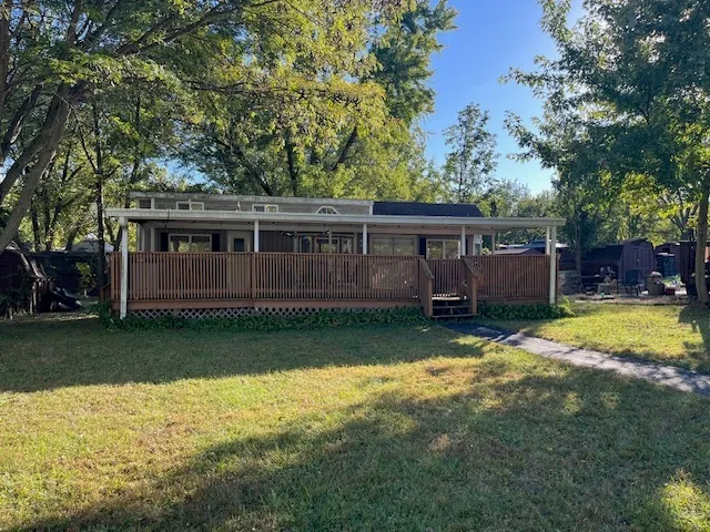 a view of a house with a yard and a tree